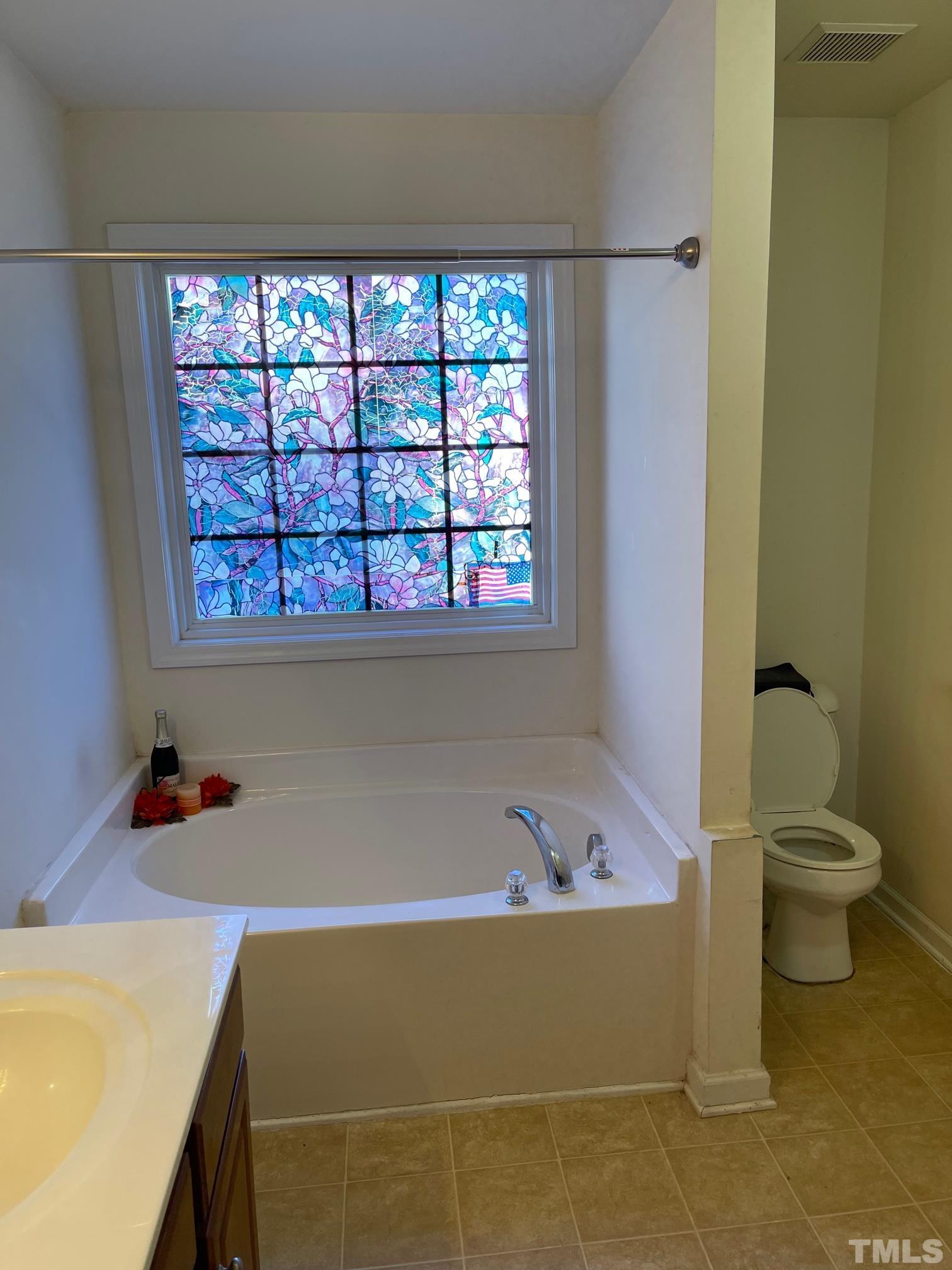 3516 Rendition Street Raleigh, NC 27610 - Photo 22 of 24 a bathroom with a bathtub and a window