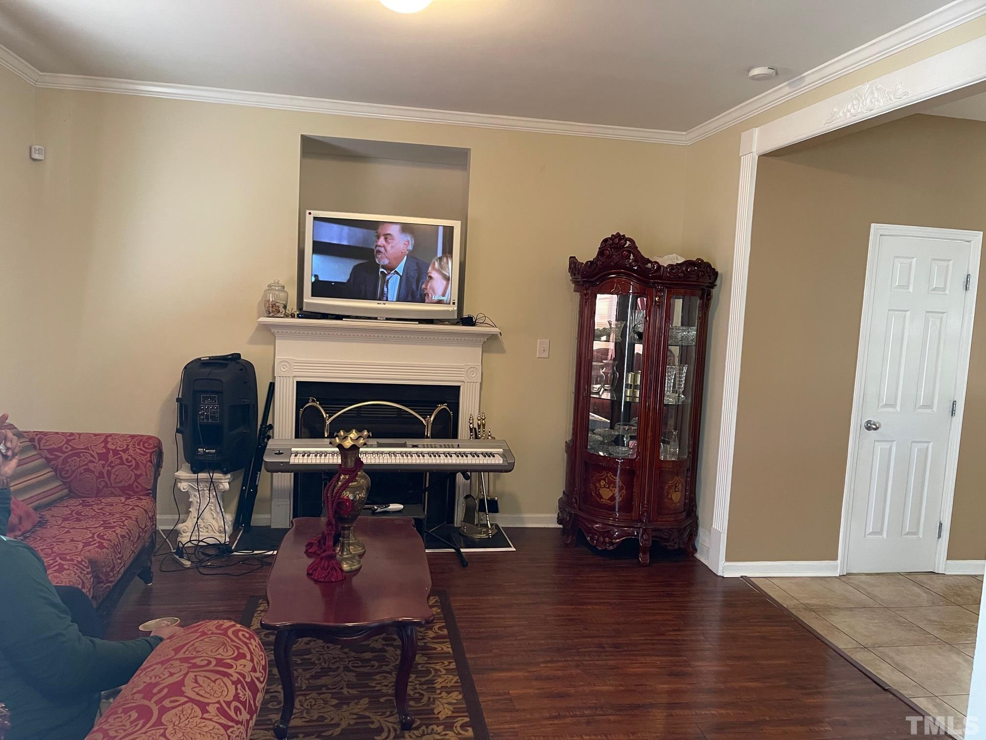 3516 Rendition Street Raleigh, NC 27610 - Photo 6 of 24 a living room with furniture and a fireplace