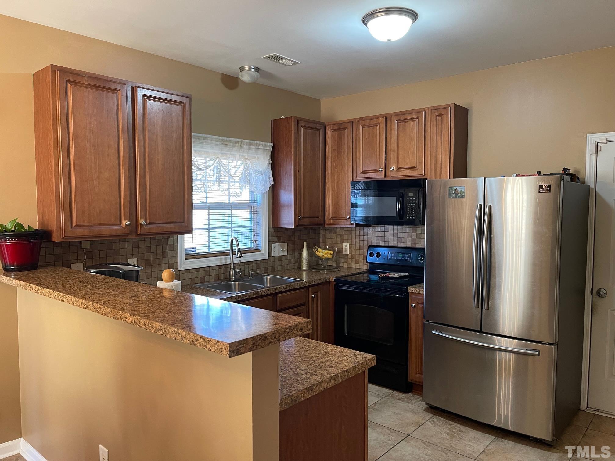 3516 Rendition Street Raleigh, NC 27610 - Photo 8 of 24 a kitchen with stainless steel appliances granite countertop a refrigerator stove a sink and dishwasher