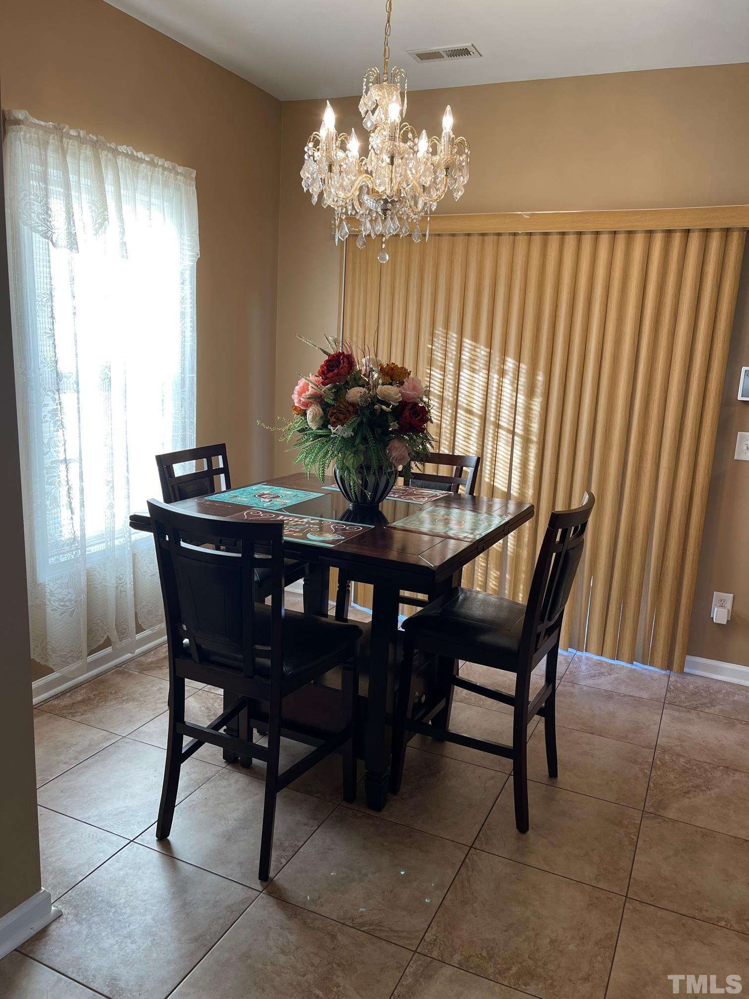 3516 Rendition Street Raleigh, NC 27610 - Photo 10 of 24 a dining room with furniture and chandelier