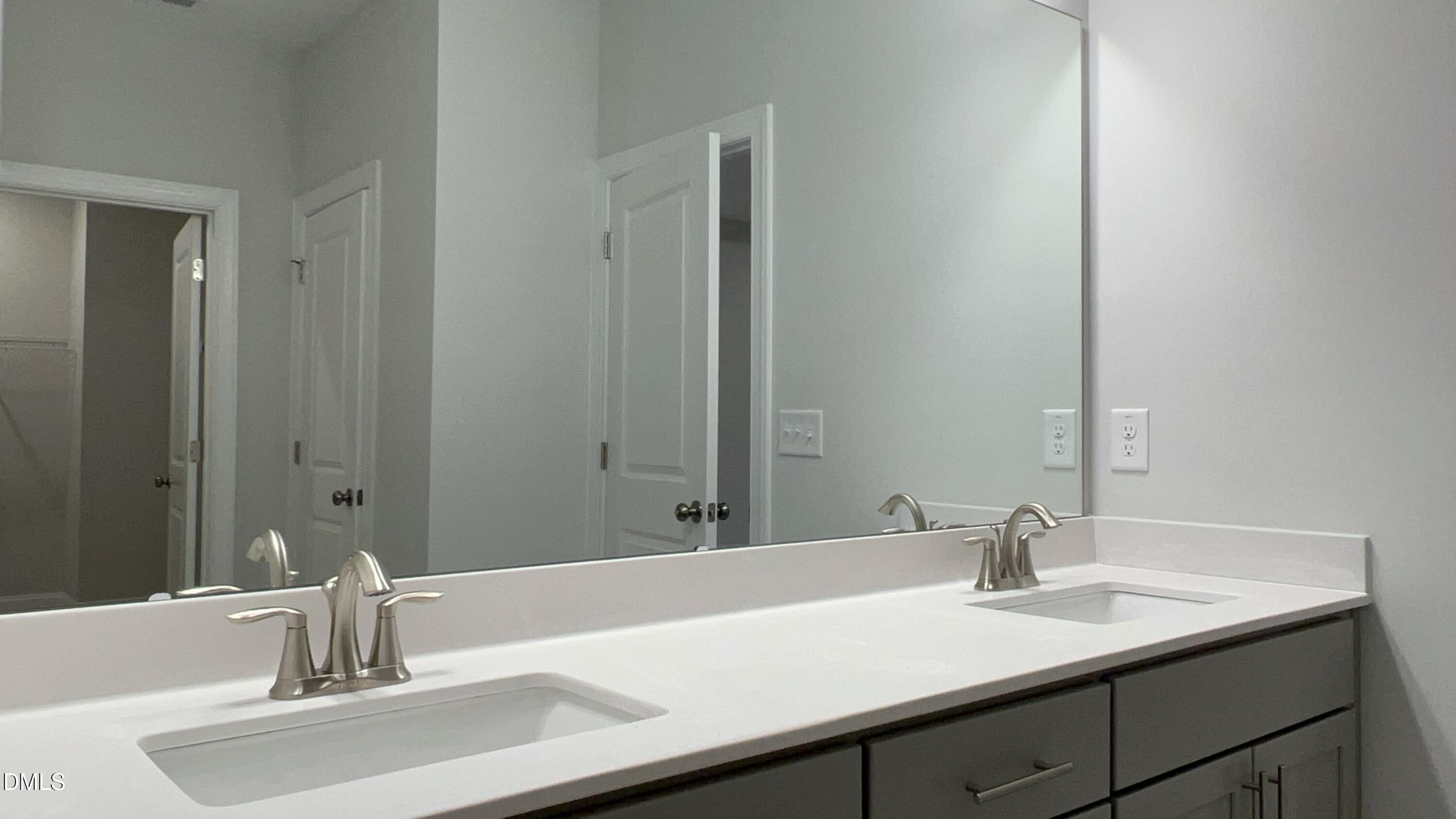 113 Corapeake Way Holly Springs, NC 27539 - Photo 14 of 20 a bathroom with a sink and a mirror
