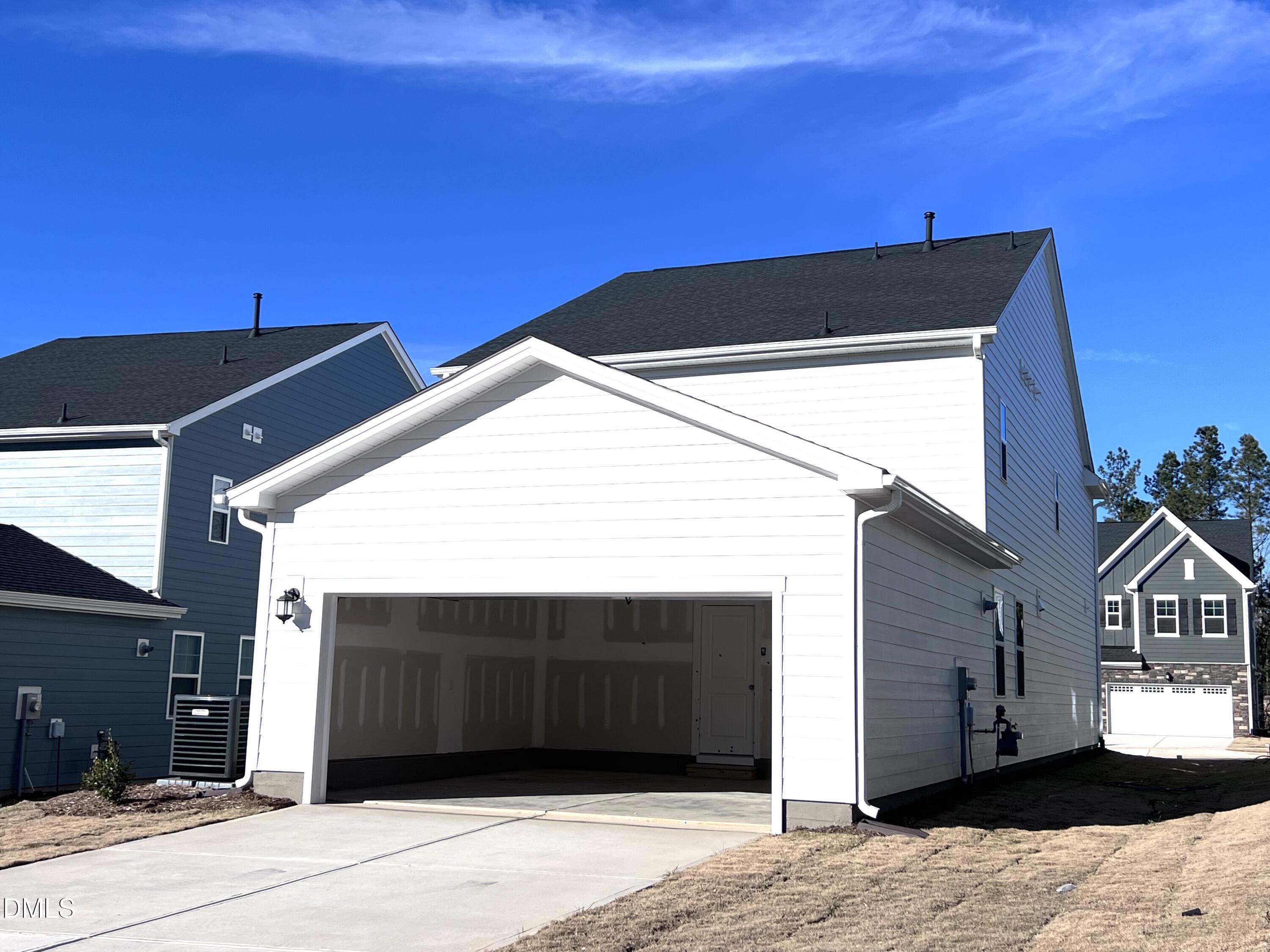 113 Corapeake Way Holly Springs, NC 27539 - Photo 18 of 20 a view of a house with a garage