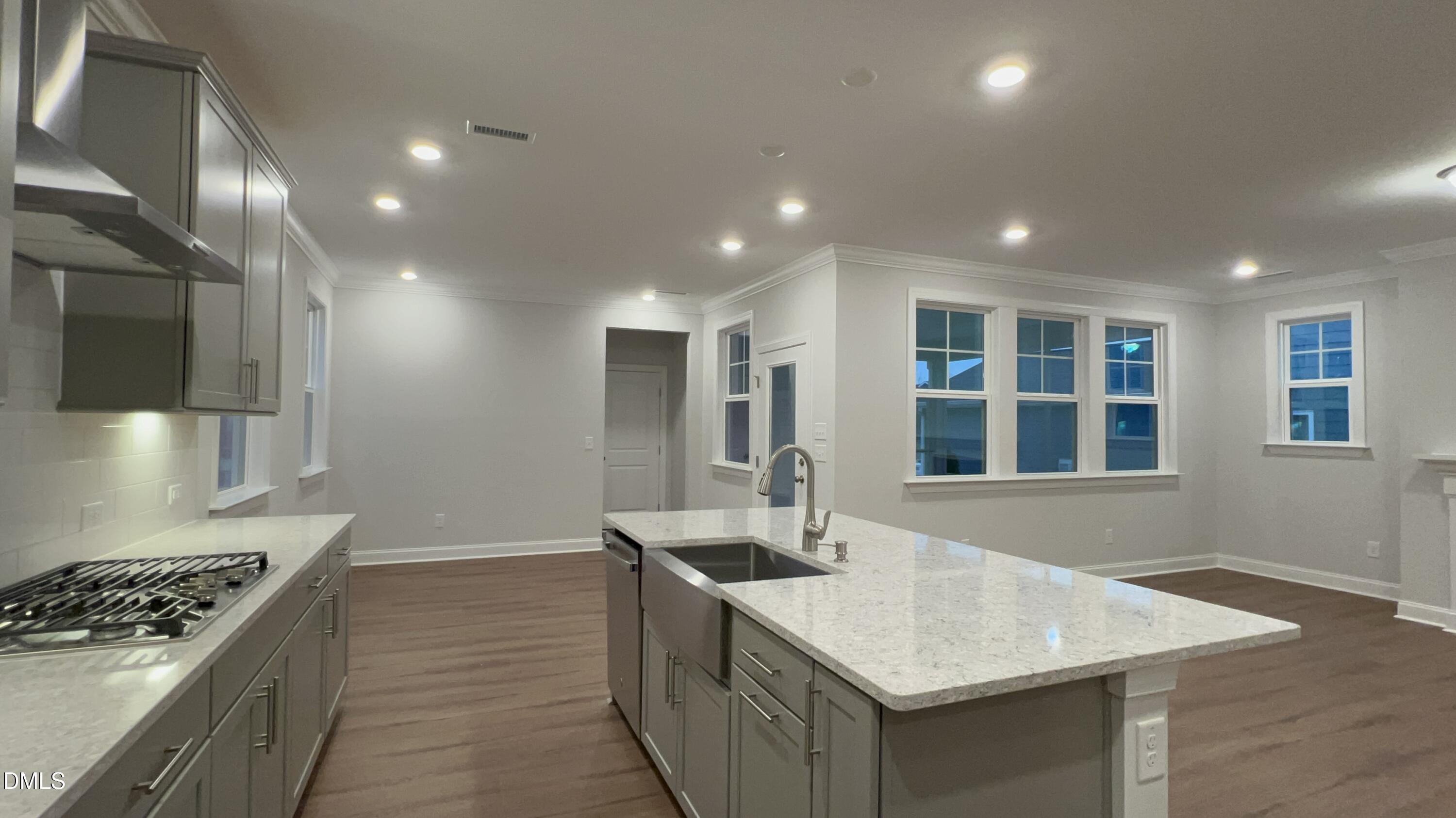 113 Corapeake Way Holly Springs, NC 27539 - Photo 2 of 20 a kitchen with granite countertop a sink stainless steel appliances and cabinets