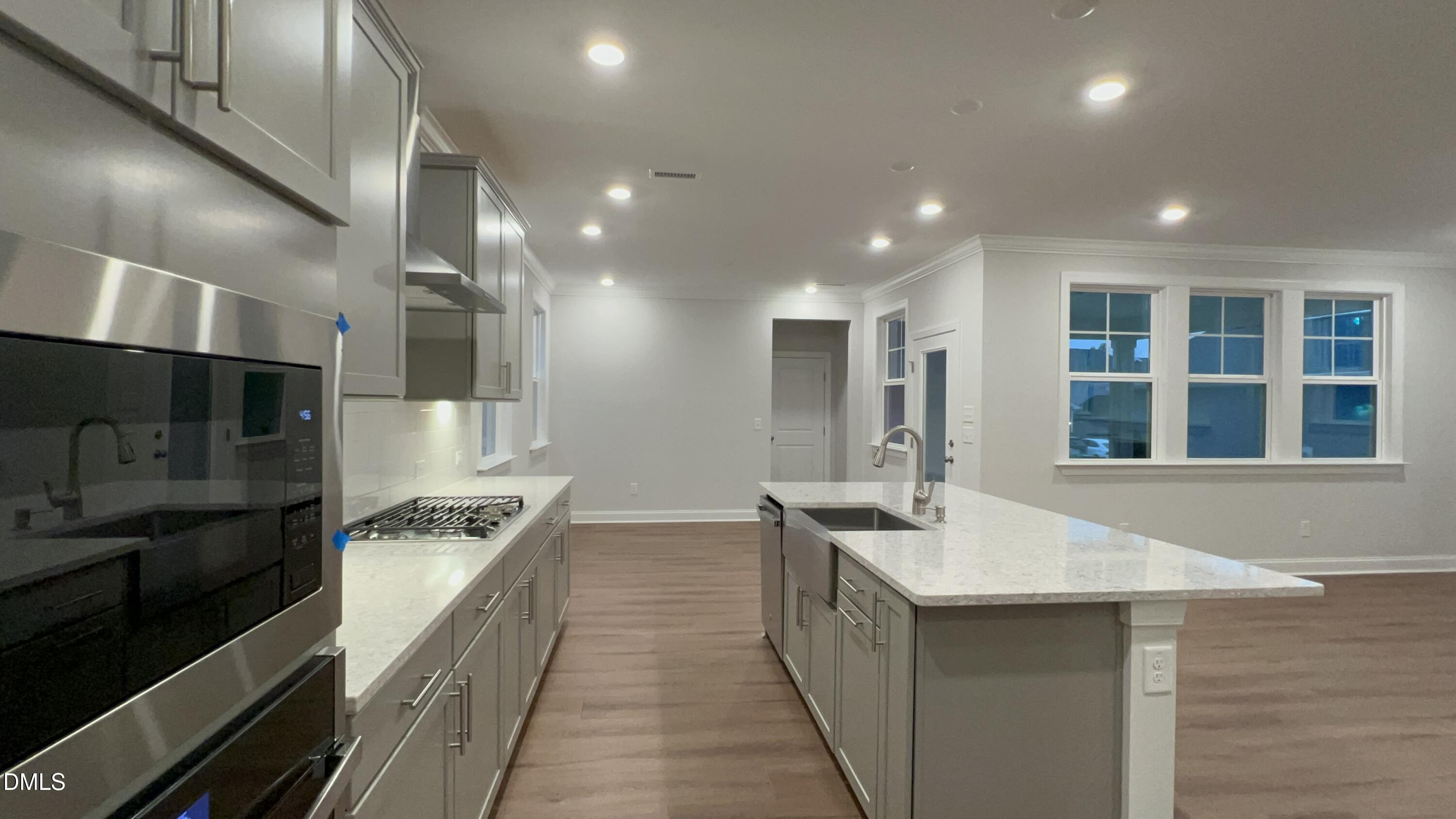 113 Corapeake Way Holly Springs, NC 27539 - Photo 4 of 20 a kitchen with stainless steel appliances granite countertop a sink stove and refrigerator