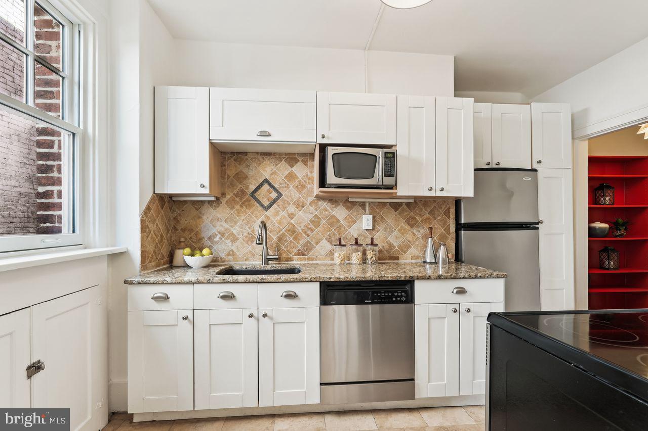 516 A Street Northeast, Unit 205 Washington, DC 20002 - Photo 13 of 24 a kitchen with stainless steel appliances white cabinets and a sink