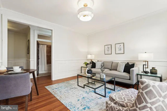 a living room with furniture wooden floor and a rug