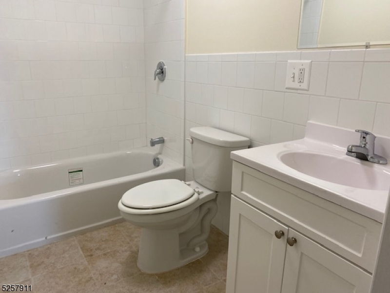 192 Market Street, Unit 7A Newark, NJ 07102 - Photo 4 of 9 a bathroom with a sink toilet and shower