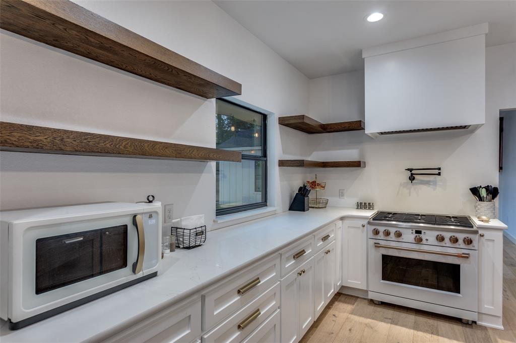3120 Colcord Avenue Waco, TX 76707 - Photo 10 of 23 a kitchen with stainless steel appliances granite countertop a sink a stove and cabinets
