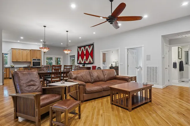 a living room with furniture and kitchen view