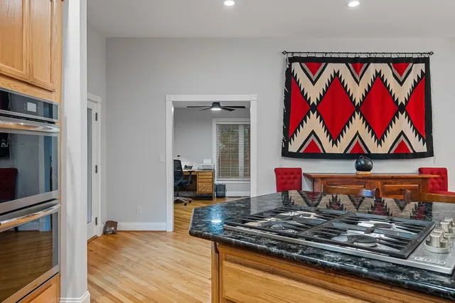 a room with stainless steel appliances granite countertop a barbecue grill and a stove top oven