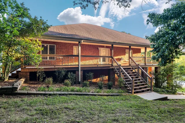a view of a patio with dining table and chairs