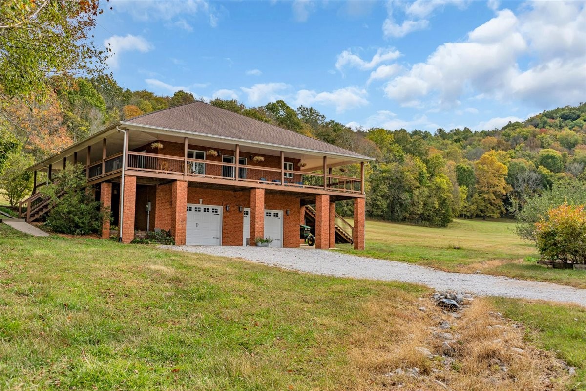 574 Hayes Ridge Road Lancaster, TN 38569 - Photo 48 of 53 a view of a large house with a big yard and large trees