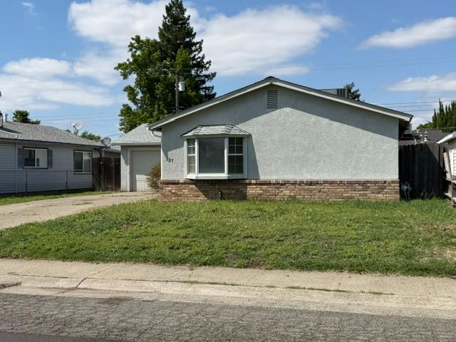 337 Quadra Avenue Rio Linda, CA 95673 - Photo 2 of 27 a view of a house with a yard plants and large tree