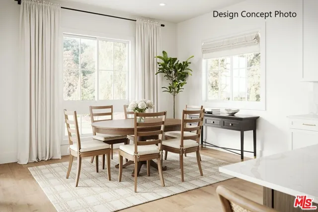 a dining room with livingroom view and wooden floor