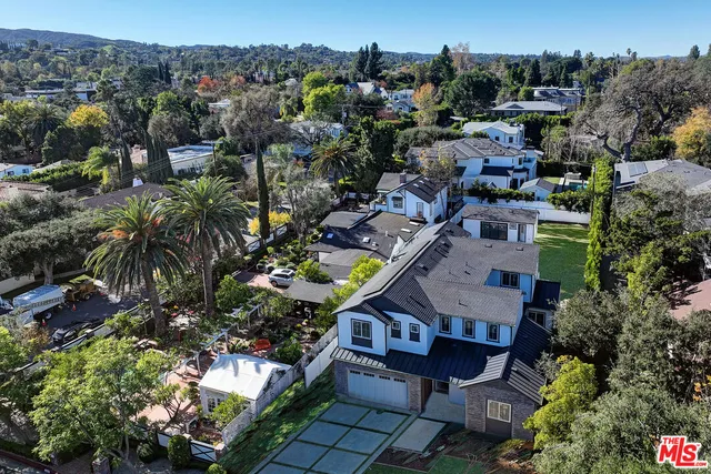 an aerial view of a house with a swimming pool outdoor seating and yard view