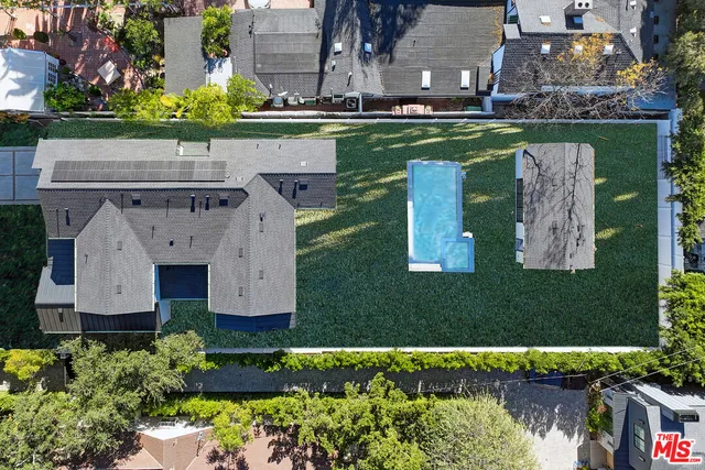 an aerial view of a house with a garden and swimming pool