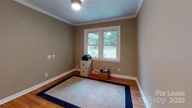 a view of a room with wooden floor and windows