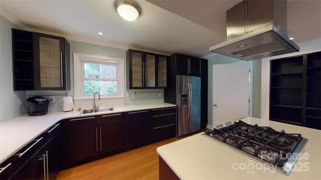 a kitchen with a sink stove and refrigerator
