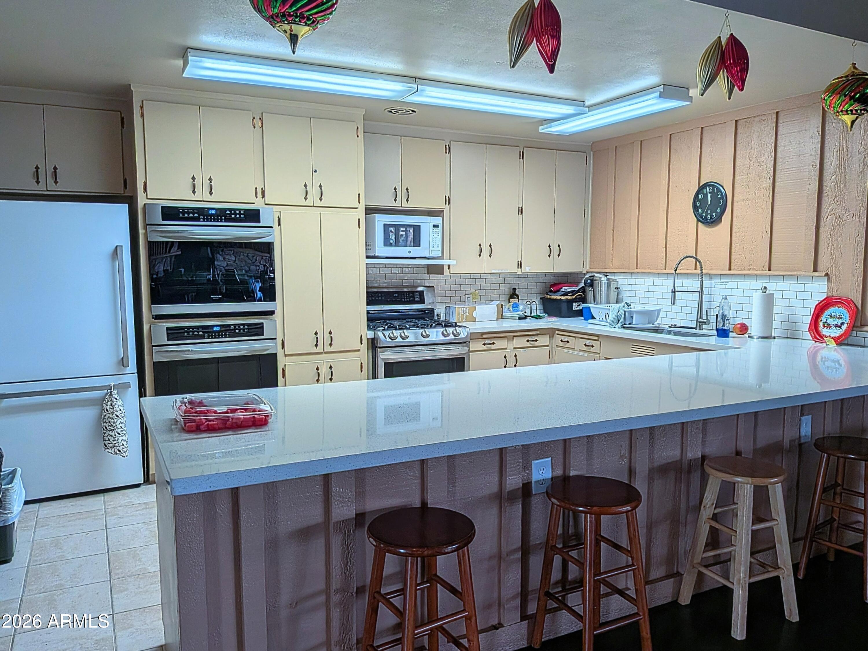 6700 East Thomas Road, Unit 25 Scottsdale, AZ 85251 - Photo 27 of 29 a kitchen with stainless steel appliances a stove a sink and cabinets