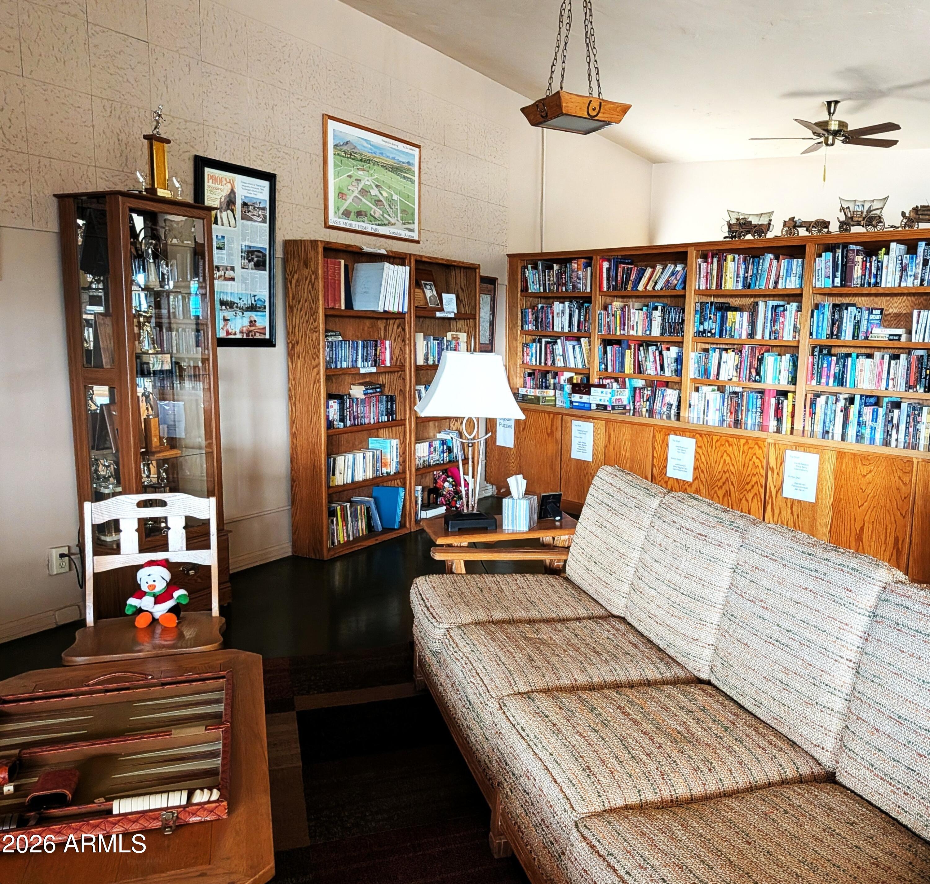 6700 East Thomas Road, Unit 25 Scottsdale, AZ 85251 - Photo 28 of 29 a living room with furniture and a book shelf