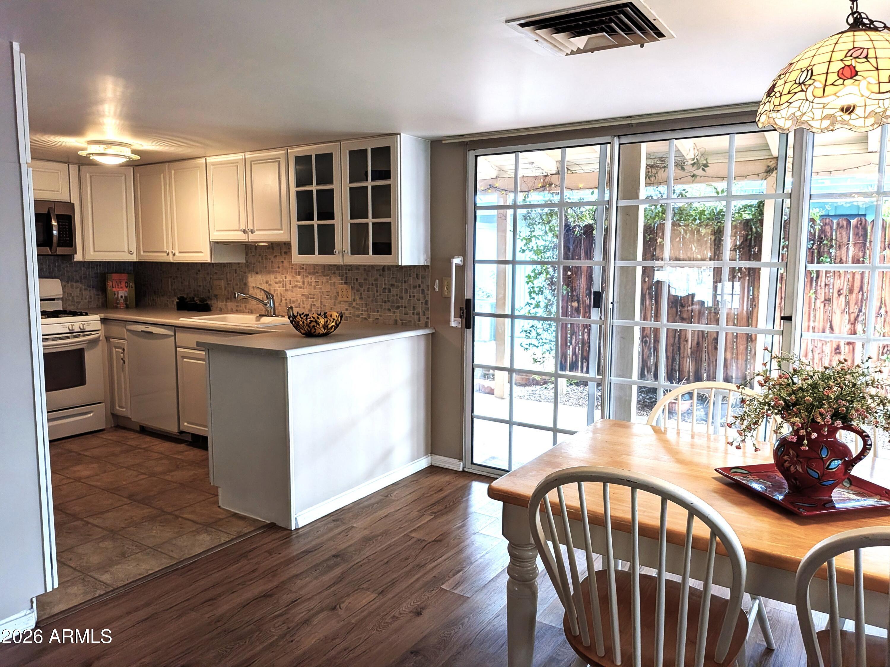 6700 East Thomas Road, Unit 25 Scottsdale, AZ 85251 - Photo 5 of 29 a kitchen with a stove a sink and a refrigerator