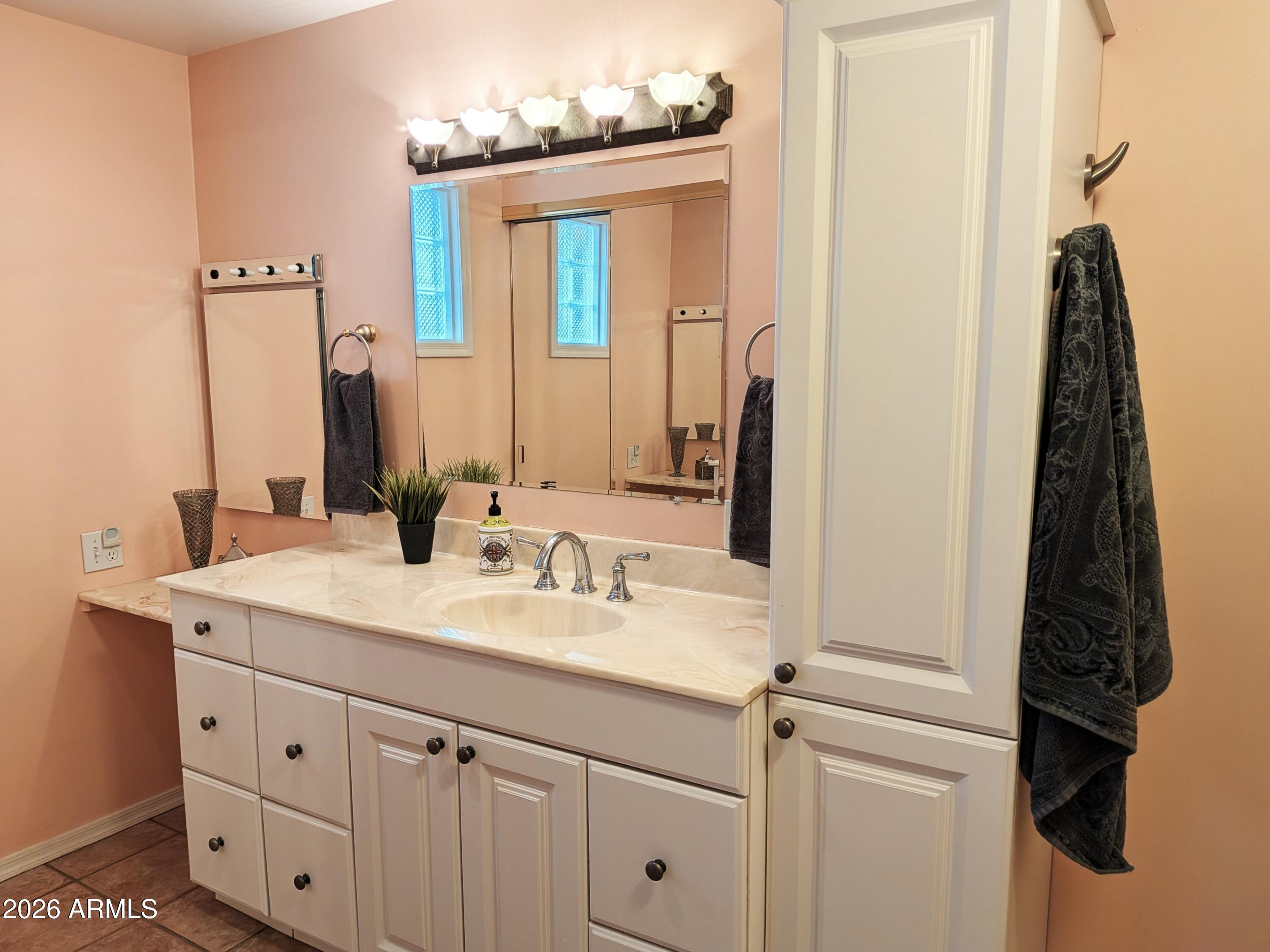 6700 East Thomas Road, Unit 25 Scottsdale, AZ 85251 - Photo 10 of 29 a bathroom with a sink vanity and mirror