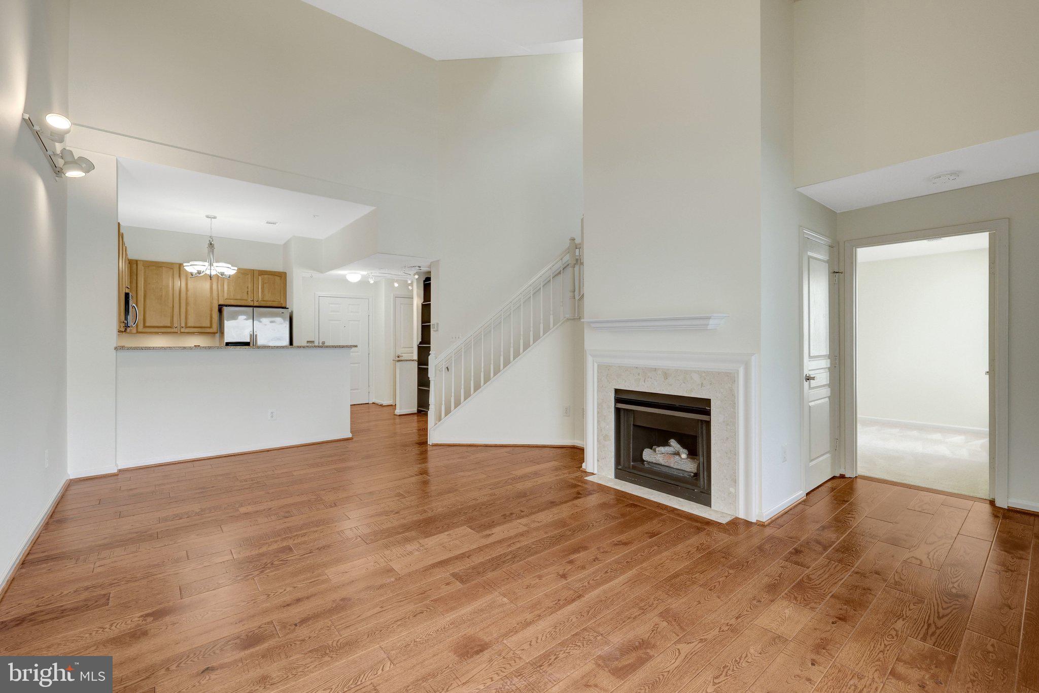 12001 Market Street, Unit 434 Reston, VA 20190 - Photo 14 of 43 a view of a kitchen and an empty room