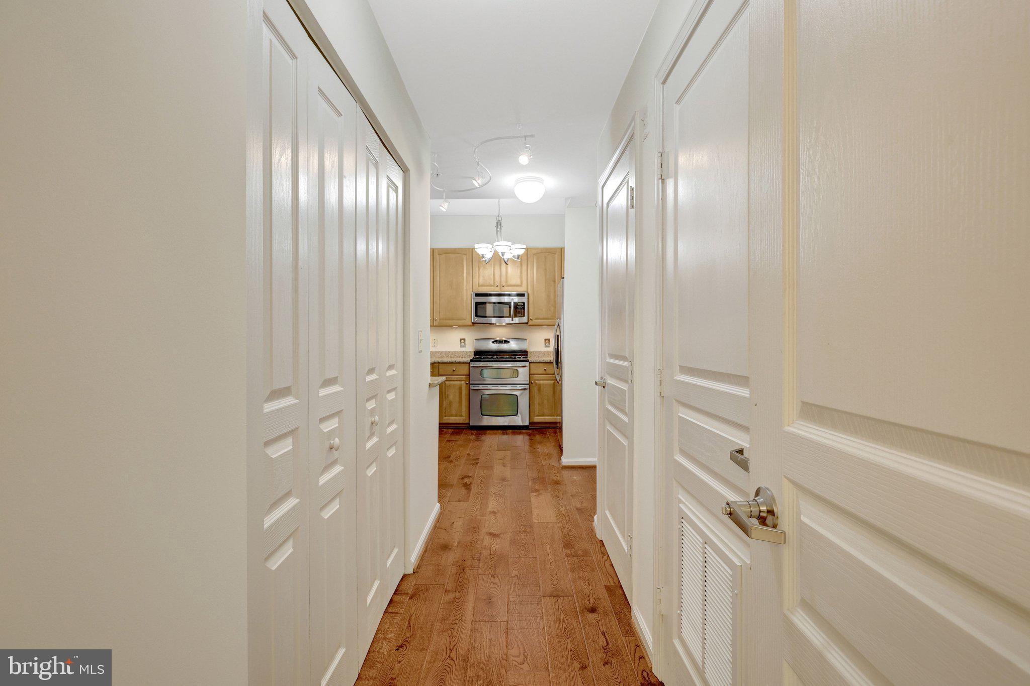 12001 Market Street, Unit 434 Reston, VA 20190 - Photo 19 of 43 a view of a hallway with wooden floor