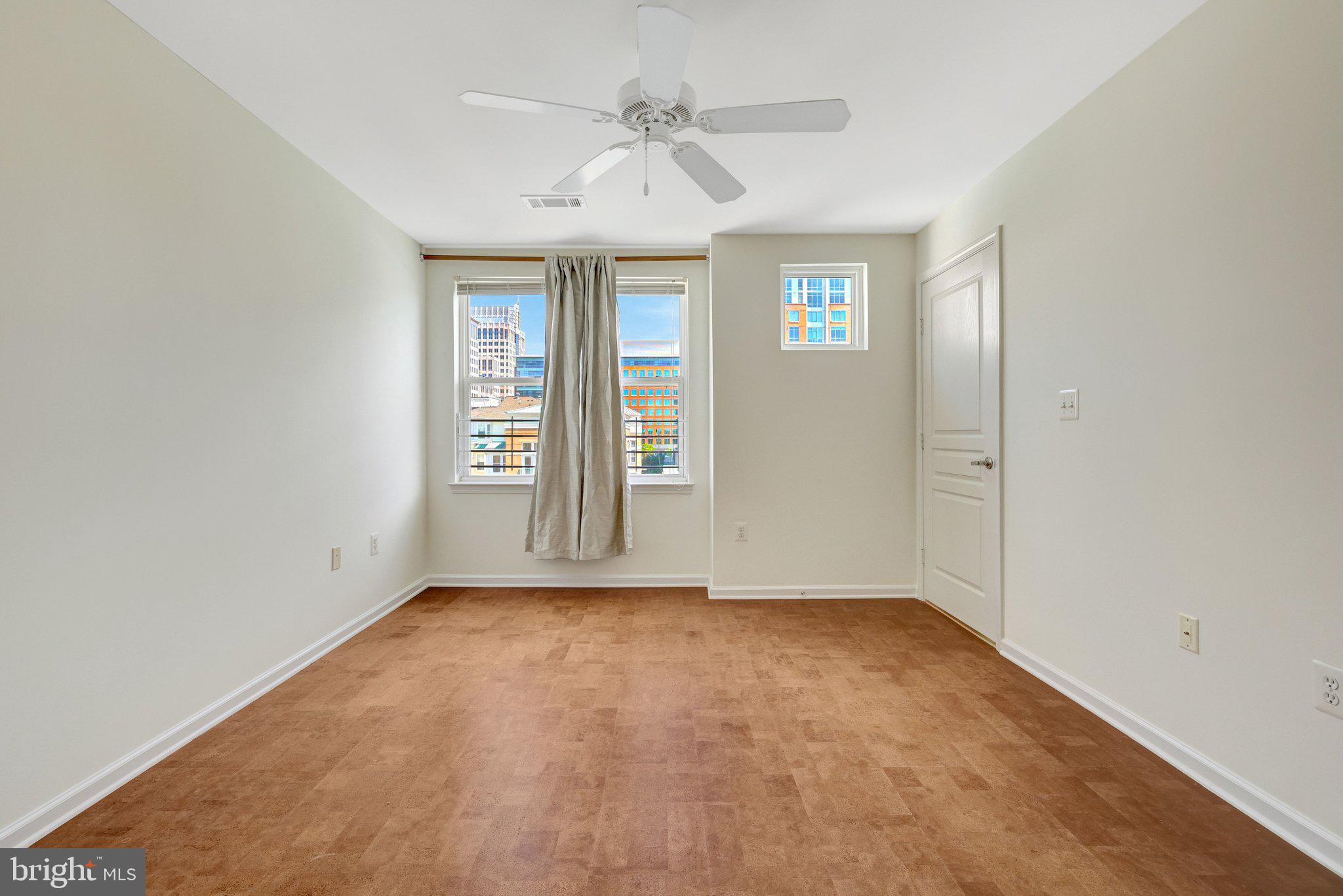 12001 Market Street, Unit 434 Reston, VA 20190 - Photo 27 of 43 an empty room with windows and closet