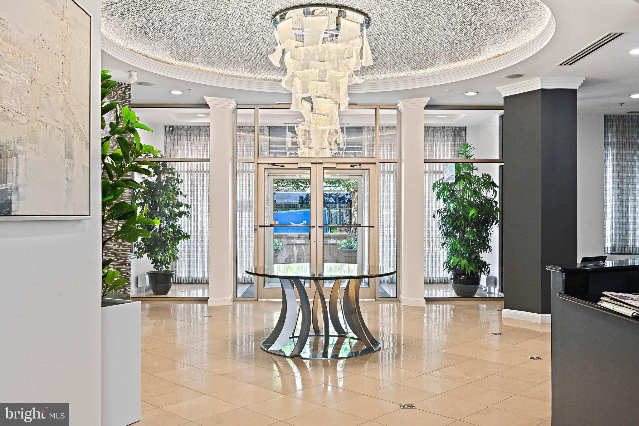 12001 Market Street, Unit 434 Reston, VA 20190 - Photo 3 of 43 a view of entryway with a floor to ceiling window and potted plants