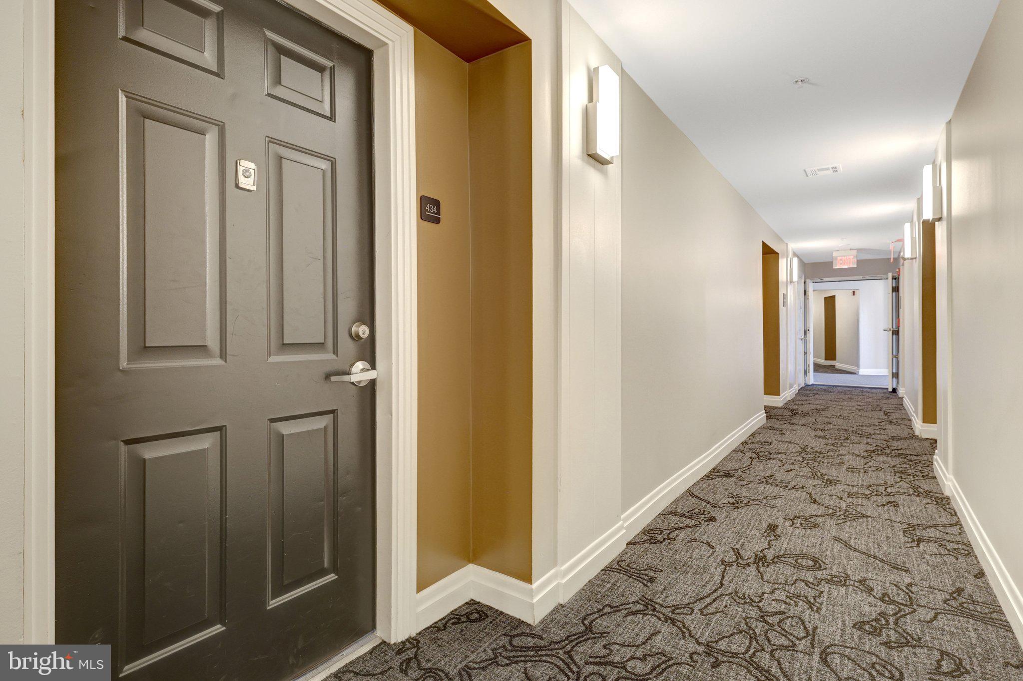 12001 Market Street, Unit 434 Reston, VA 20190 - Photo 32 of 43 a view of a hallway with wooden floor and staircase
