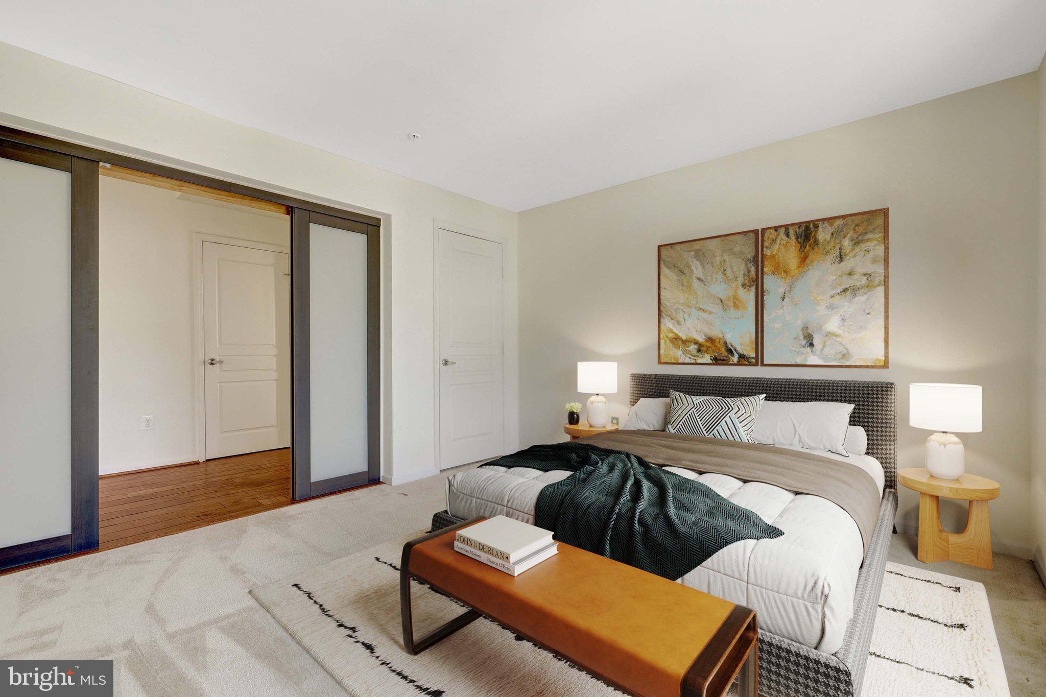 12001 Market Street, Unit 434 Reston, VA 20190 - Photo 5 of 43 a bedroom with a bed and wooden floor