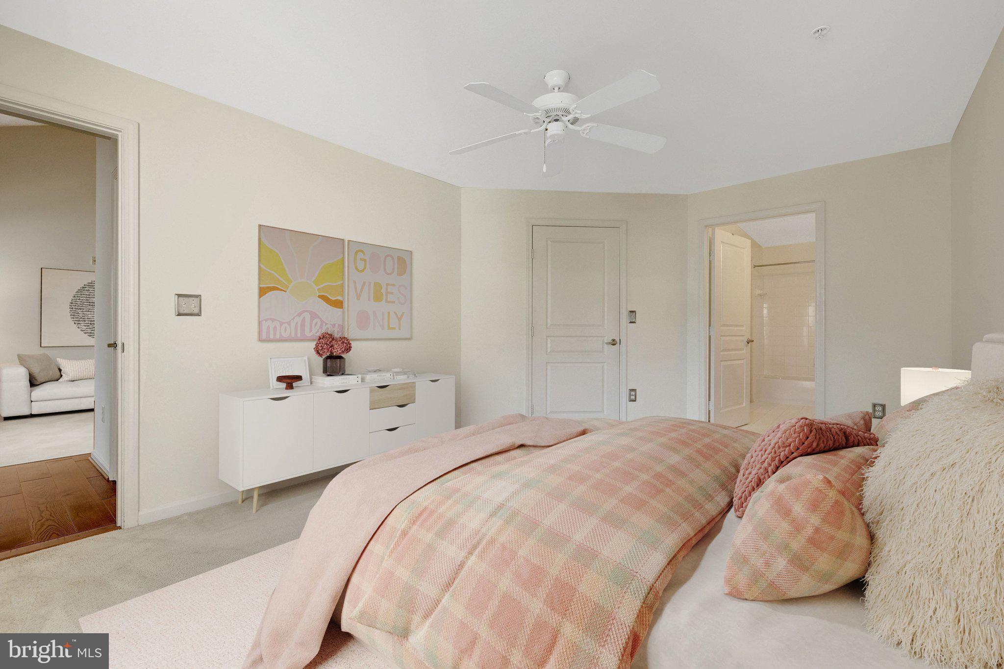 12001 Market Street, Unit 434 Reston, VA 20190 - Photo 6 of 43 a bedroom with a bed and a chandelier