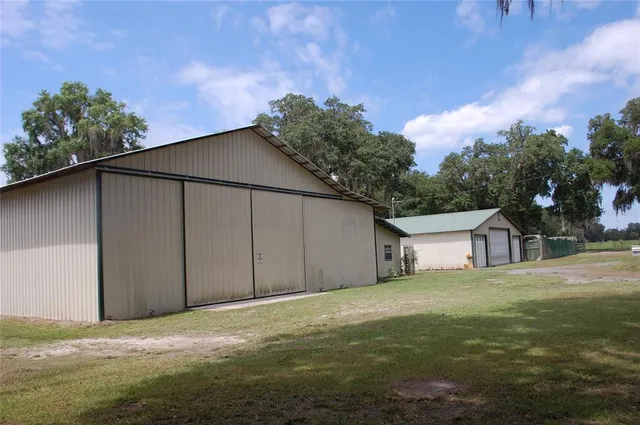 a backyard of a house with lots of green space and wooden fence
