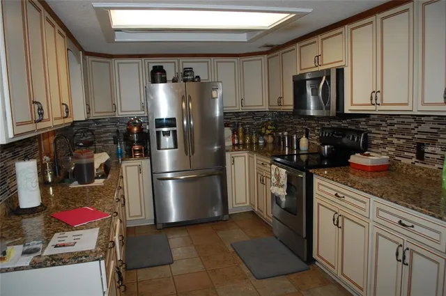 a kitchen with a refrigerator stove and microwave