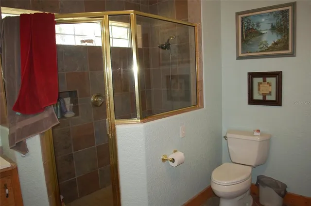 a bathroom with a toilet and a shower