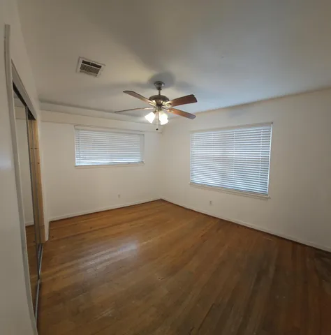 a view of a room with wooden floor and staircase
