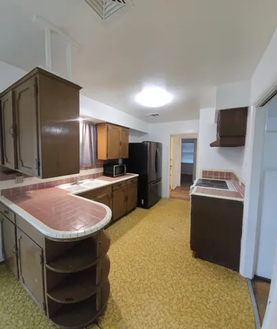 a kitchen with stainless steel appliances granite countertop a sink and a stove