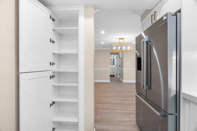 a view of an empty room with wooden floor