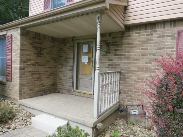 a brick house with a large windows