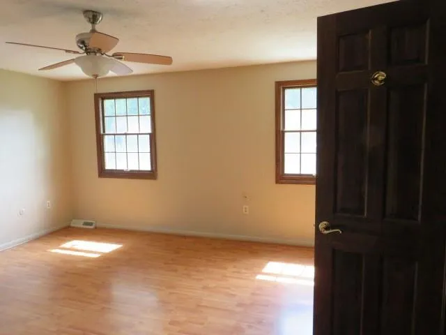 a view of an empty room with a window
