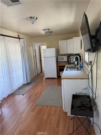 a view of balcony with wooden floor and fence