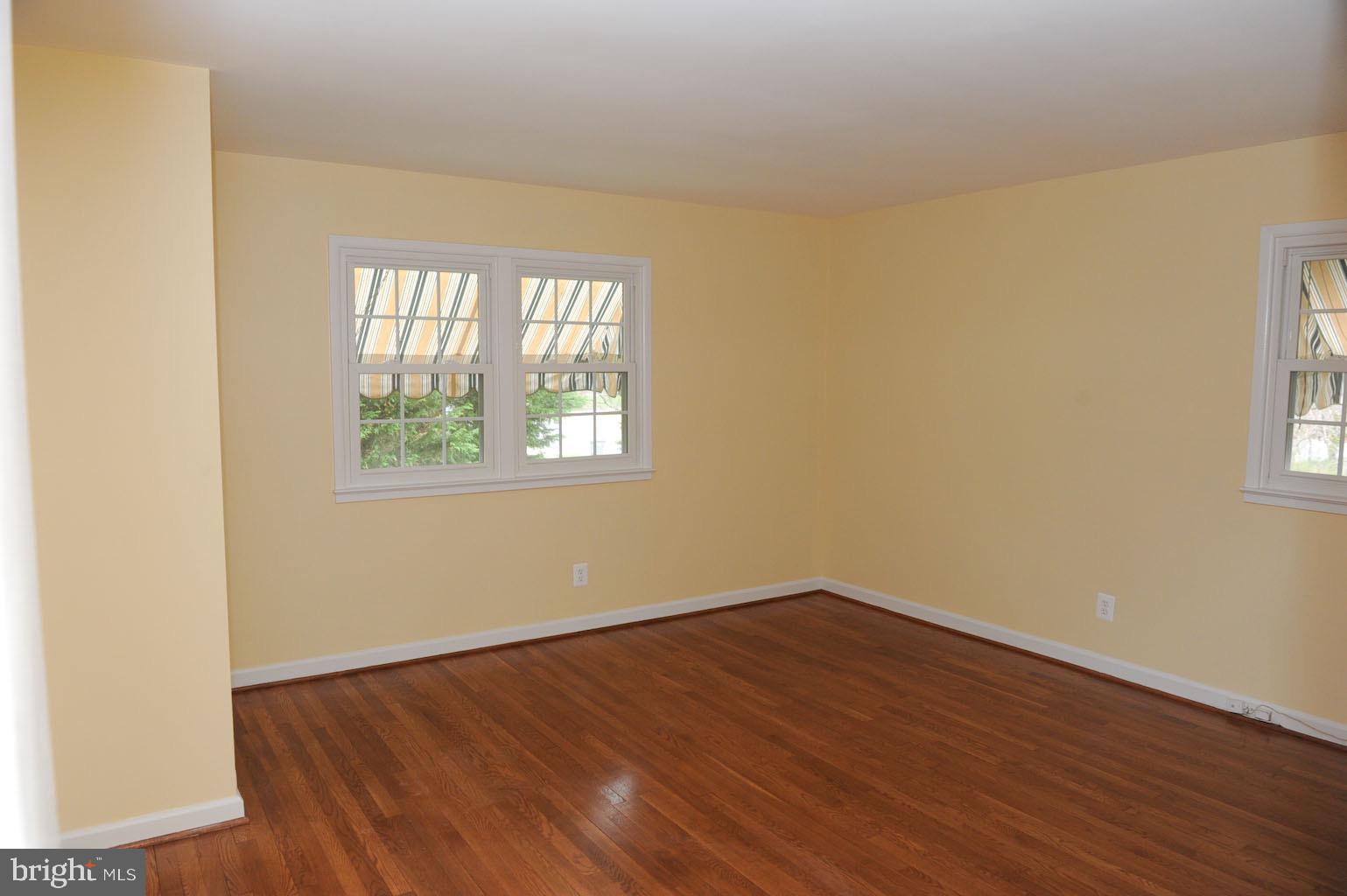 1342 Mayflower Drive McLean, VA 22101 - Photo 12 of 14 an empty room with wooden floor and windows