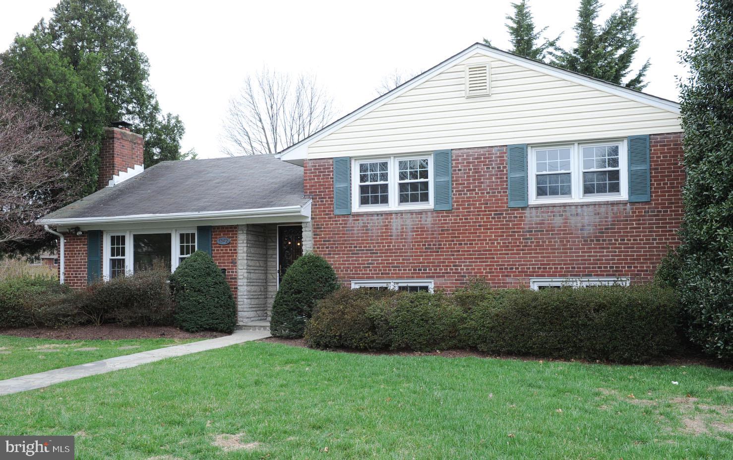 1342 Mayflower Drive McLean, VA 22101 - Photo 2 of 14 a front view of a house with a garden