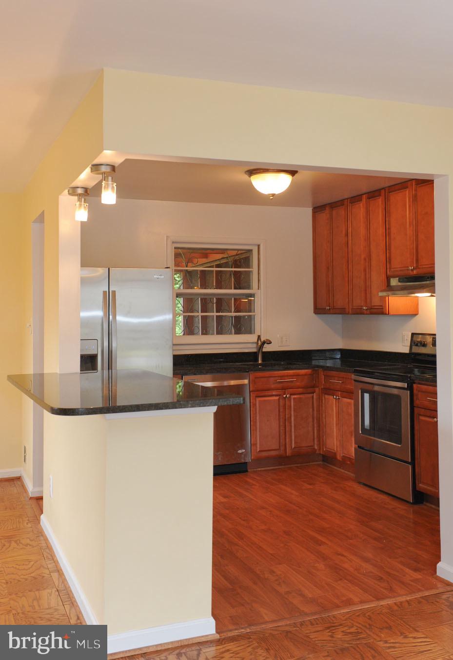 1342 Mayflower Drive McLean, VA 22101 - Photo 6 of 14 a kitchen with stainless steel appliances kitchen island granite countertop a stove a sink and a refrigerator