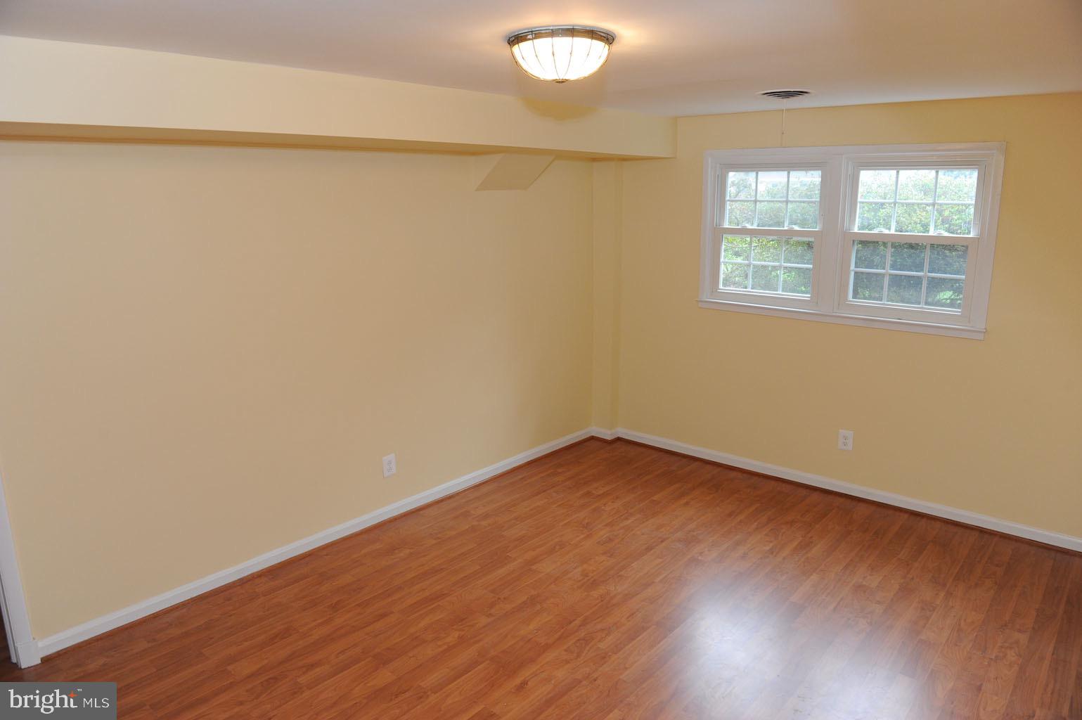 1342 Mayflower Drive McLean, VA 22101 - Photo 9 of 14 wooden floor in an empty room with a window