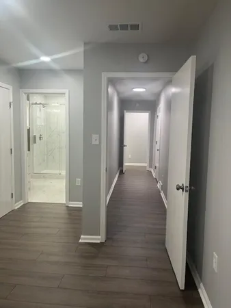 a view of a hallway with wooden floor