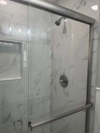 a bathroom with a glass shower door