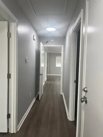 a view of a hallway with wooden floor