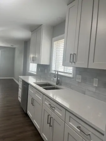 a kitchen with a sink cabinets and window